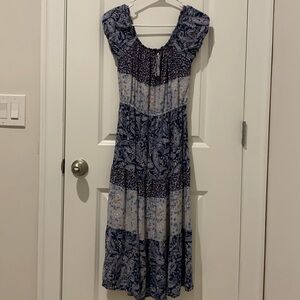This is an unbranded, multi patterned dress with shades of blue and pink.